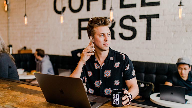 Marketing to millennials - young man in coffee shop on phone