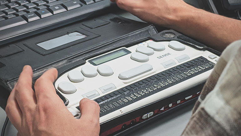 website accessibility person using a braille screen reader